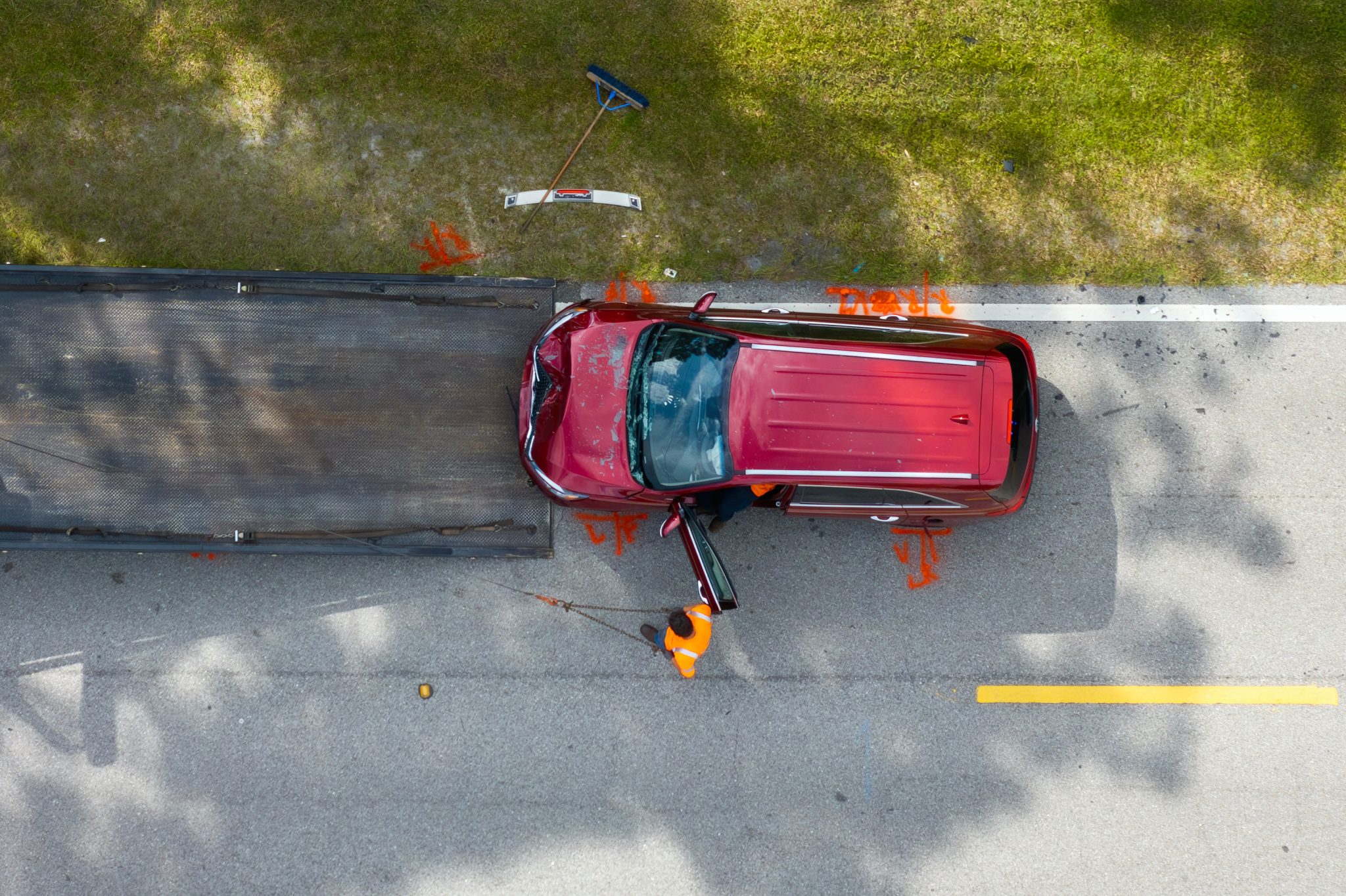 Car Crash Site With Tow Truck Loading Destroyed Vehicle On American Street. Emergency Services Personnel Responding To Accident In Florida, Usa